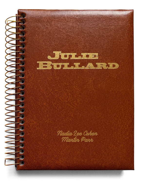 Brown notebook with gold text on a white background