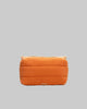 Orange toiletry bag with a visible brand logo on a white background