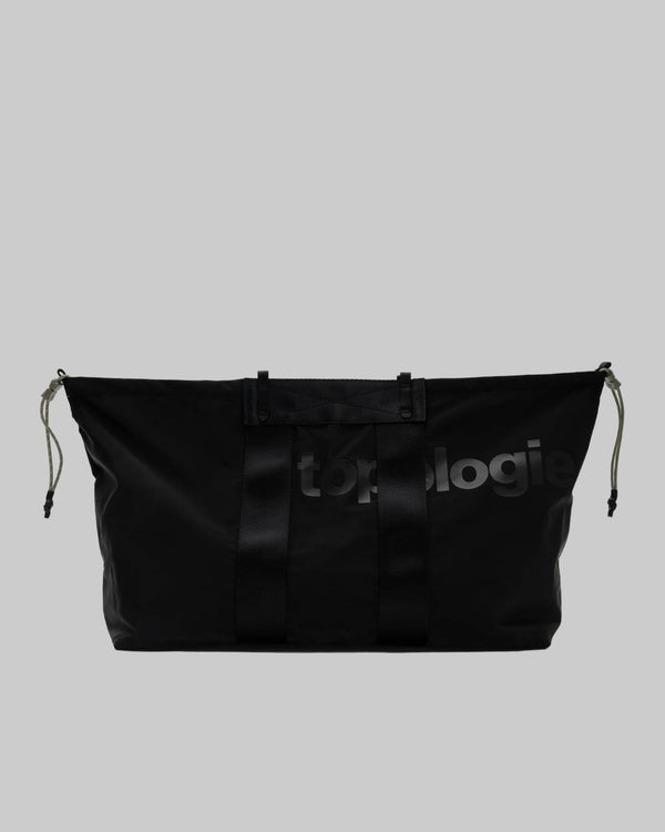 Black bag with 'topologie' branding on a gray background