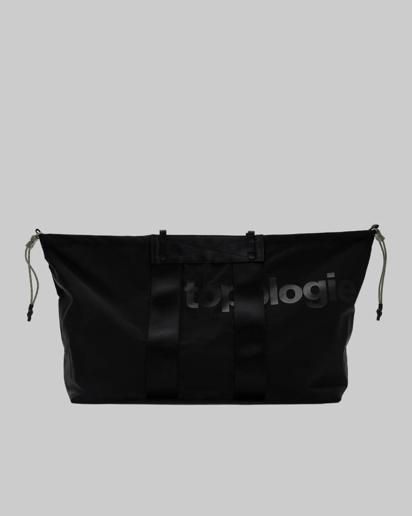 Black bag with 'topologie' branding on a gray background