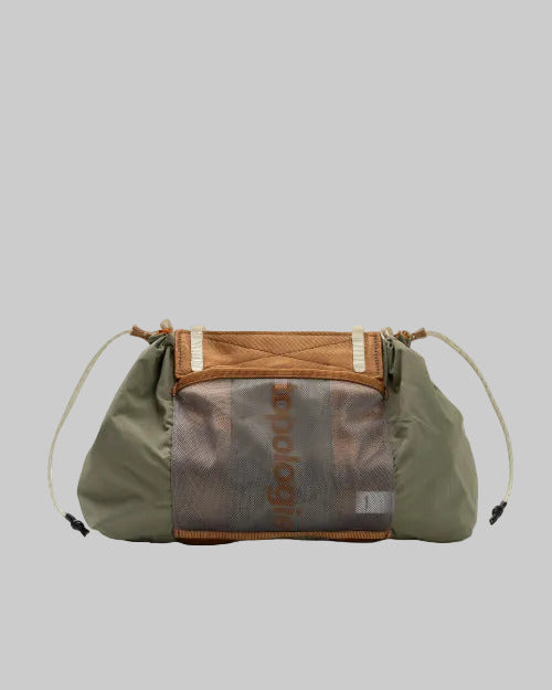 Green and brown bag with a transparent section displaying text on a white background